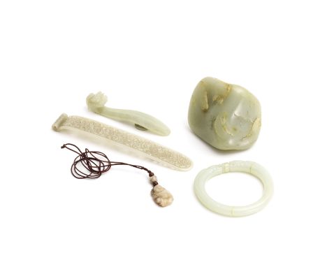 A GROUP OF FIVE JADE CARVINGS17th century and laterComprising: a reticulated hairpin carved with scrolling foliate lotus stem