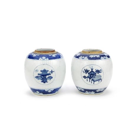 A PAIR OF BLUE AND WHITE GINGER JARSKangxiThe fluted body with three blue and white roundels enclosing precious objects, in b