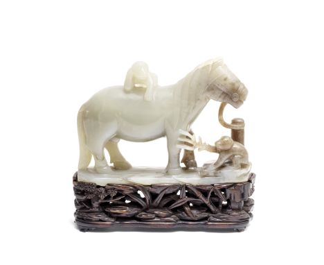 A PALE GREEN JADE 'HORSE AND MONKEYS' GROUP18th centuryThe mottled pale green group with a horse standing tied to a post, one