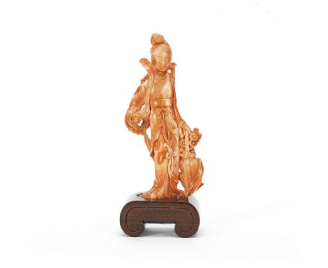 A CORAL CARVING OF MAGULate Qing DynastyThe standing lady wearing ample robes with a billowing celestial scarf, holding a lar