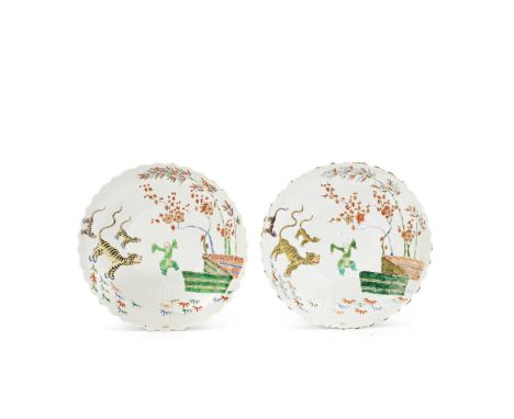 A PAIR OF KAKIEMON STYLE DISHESKangxiOf lobed chrysanthemum form, each decorated to the centre with an animated boy beside th