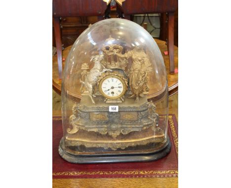 Ornate gilt metal mantel clock under glass dome