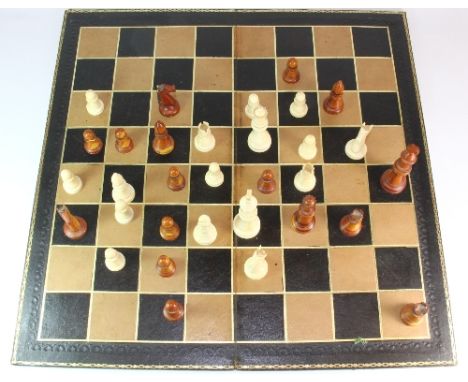 An attractive 1930s turned ivory and box wood chess set and leather covered board
