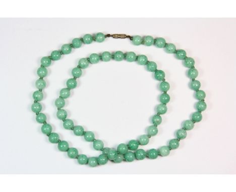 A single strand 1920s / 1930s necklace of 9.5mm jade / hardstone beads