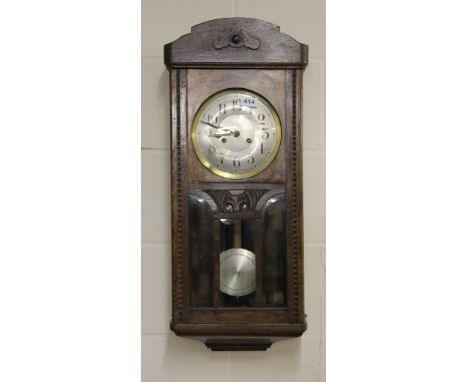 A striking oak wall clock