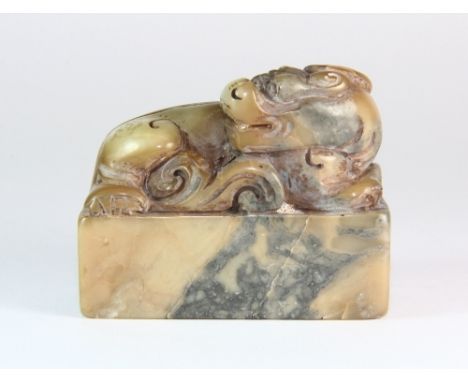 A 19th / early 20th century Chinese carved soapstone seal mounted with a dragon L 6cm H 5cm