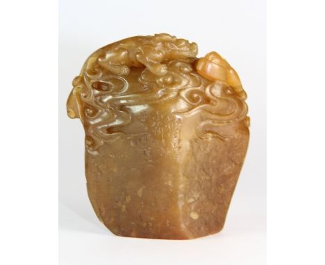 An early 20th century Chinese carved soapstone seal mounted with 3 young dragons playing on a rock H 8cm