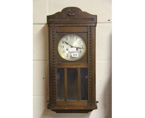 A striking oak wall clock