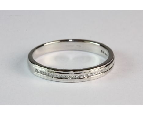 A platinum and channel set diamond half eternity ring (O.5)