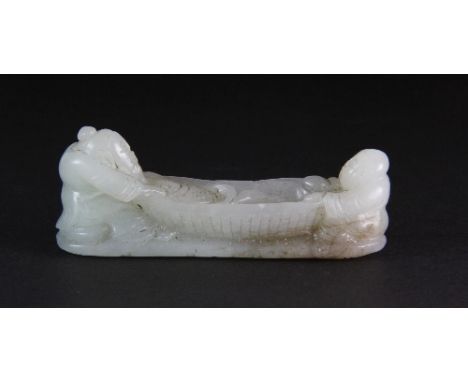 An early 20th century Chinese carved jade figure of a fisherman and a boy on a bamboo raft L 8cm H 3cm