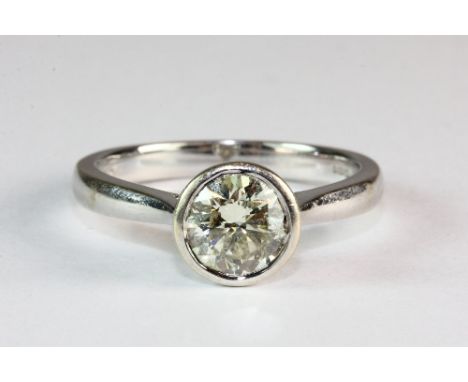 An 18ct white gold diamond solitaire ring (approx. 1.1ct) in a rub over setting (N)