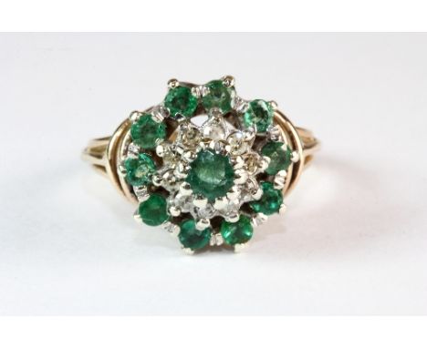 A 9ct yellow and white gold emerald and diamond cluster ring (L)