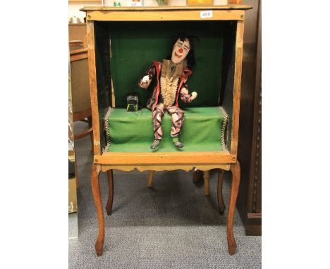 A clockwork cabinet clown automaton, cabinet size 94cm x 56cm