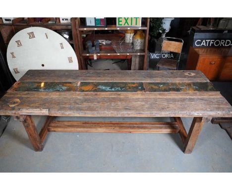 A pine workbench dining table by Parry &amp; Sons of Shoreditch,mid-20th century and later, the plank top fitted with a centr