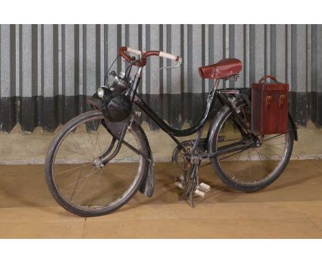 A VeloSolex '330 model' motorised bicycle,c.1950s and later, with a 45cc engine, leather handles, seat and pannier, 56cm wide