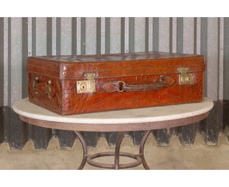 An Edwardian crocodile leather gentleman's vanity case,early 20th century and later, the hinged lid enclosing two lift-out co