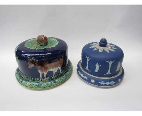 A majolica cheese dome decorated with scenes of cow and surmainted by cow finial, a jasperware ceramic cheese dome and Wedgwo