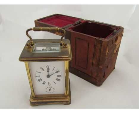 A leather cased brass carriage clock 