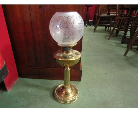 A brass oil lamp, ridged base embossed reservoir, etched glass shade, no chimney, 52cm tall 