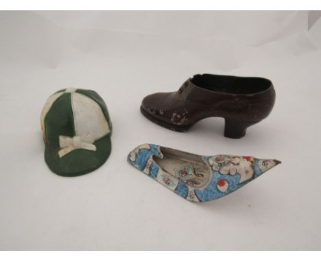 A painted metal love token shoe, the sole inscribed "To G.E. from G.C. 1932" 12cm long, painted jockey cap 9cm long, and enam