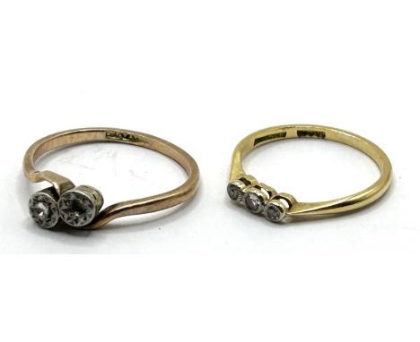 A 9ct gold and three stone diamond ring, ring size M, and a 9ct gold and diamond ring, lacking one stone, ring size M (2) 