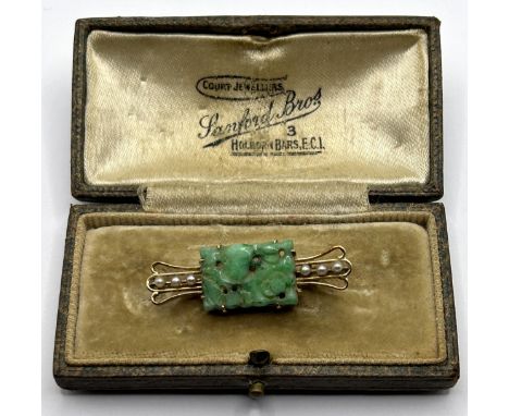 An Art Deco seed pearl and carved green stone bar brooch, in a vintage jewellery box 