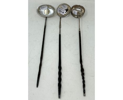 A George III toddy ladle, inset with a coin, another, and a George III toddy ladle (3) 