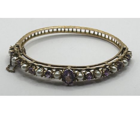 A gold, cultured pearl and amethyst hinged bangle24 g all in 