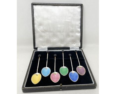 A George V set of six silver and multi-coloured enamel coffee spoons, with bean handles, cased 