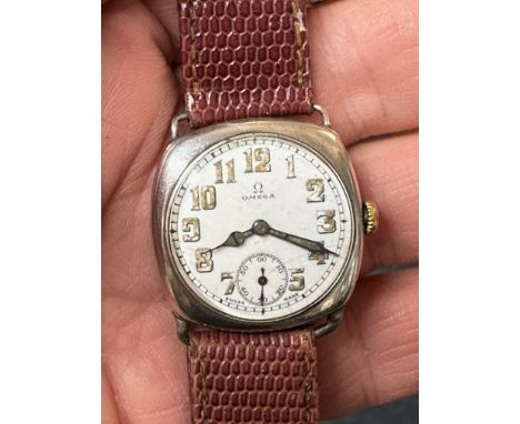 A gentleman's silver Omega wristwatch, the enamel dial with Arabic numerals and subsidiary seconds dial, and a (later) Omega 