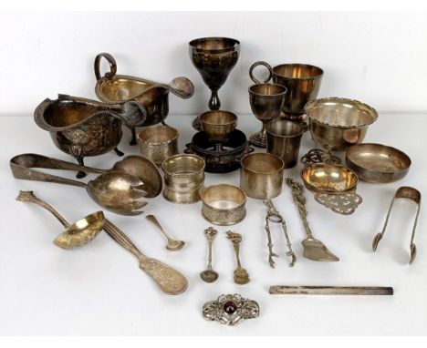 A George V silver sugar bowl, a strainer, four napkin rings, an egg cup, various dates and marks, 3.4 ozt, and assorted silve