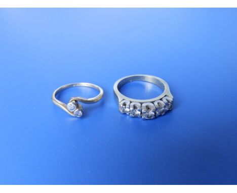 A small two stone diamond crossover set gold ring and a half eternity ring set with colourless stones - '750'. (2)