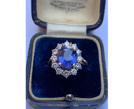 A certified natural colour change Sri-Lankan sapphire &amp; diamond cluster ring, the oval mixed cut 4 carat sapphire raised 