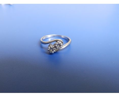 A small two stone diamond crossover set 18ct white gold ring.  Finger size L.