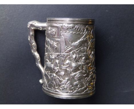 An antique Chinese silver tankard, having raised decoration depicting battle scenes, angular branchiform handle, a small insc