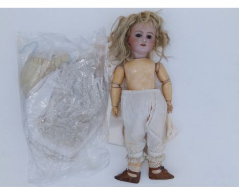 A German bisque head girl doll - 'Germany 5', having brown paperweight eyes, jointed composition limbs, 13.5".
