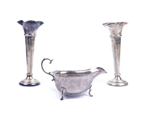 A PAIR OF SILVER VASES AND A SILVER SAUCEBOAT (3)The vases of trumpet shaped form, each raised on a weighted circular foot, h