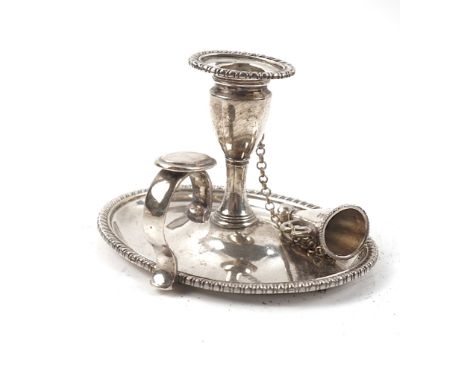 A GEORGE III SILVER CHAMBER CANDLESTICKOf oval form, having a detachable sconce and a snuffing cone, fitted to a chain, the s