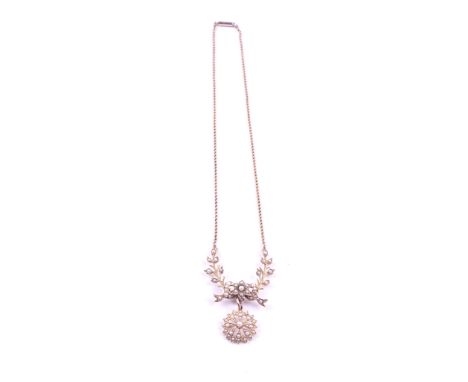 A GOLD AND SEED PEARL PENDANT NECKLACECirca 1900, the front with a detachable flowerhead shaped drop, detailed 15 CT, with a 