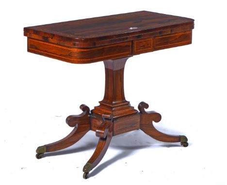 A REGENCY SATINWOOD BANDED ROSEWOOD CARD TABLEThe fold over D-shaped top on stepped square columns and four downswept support