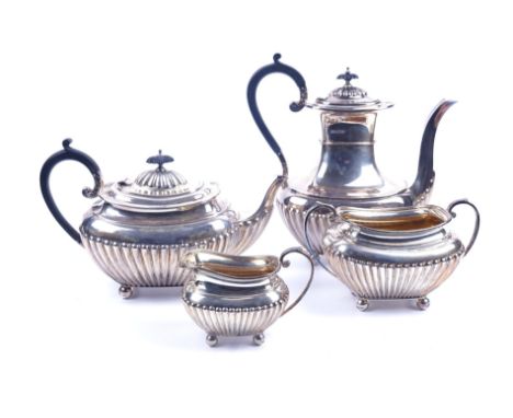 A SILVER FOUR PIECE TEA AND COFFEE SET (4)Comprising; a teapot and a coffee pot, with black composition handles and finials, 