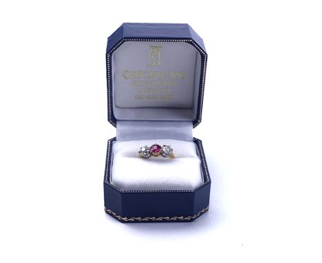 AN 18CT GOLD, RUBY AND DIAMOND THREE STONE RINGClaw set with the ruby to the centre between two cushion shaped diamonds, ring