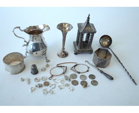 A SILVER CREAM JUG AND FURTHER ITEMS (QTY)Comprising; the cream jug with a scrolling handle, raised on three feet, Chester 19