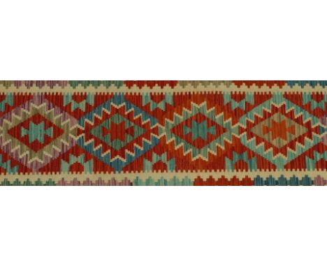 AN ANATOLIAN DESIGN KILIMThe madder field with eight single diamonds with a ware border, in very good condition; 300cm x 74cm