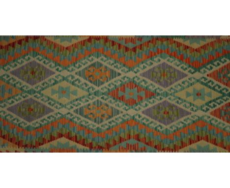 AN ANATOLIAN DESIGN KILIMThe field with a trellis of diamonds each bearing a hooked motif, a banded shaped border, in very go