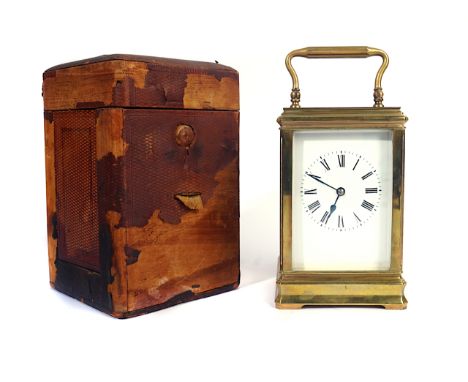 A FRENCH BRASS CASED CARRIAGE CLOCK WITH KEY AND OUTER CASELate 19th CenturyThe white enamel dial with Roman numerals, visibl