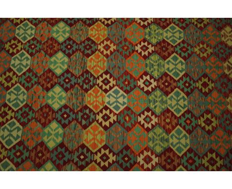 A LARGE ANATOLIAN  DESIGN KILIM CARPETthe polychrome field with interconnecting diamond motifs, within various borders, in ve