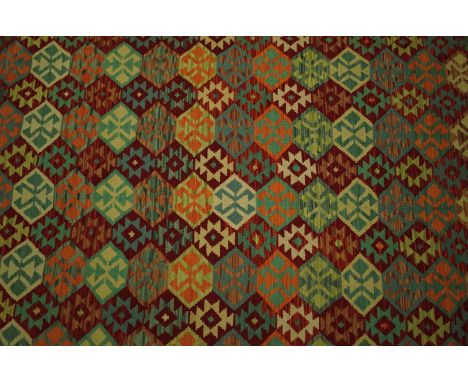 A LARGE ANATOLIAN  DESIGN KILIM CARPETthe polychrome field with interconnecting diamond motifs, within various borders, in ve