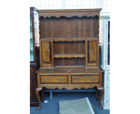 AN 18TH CENTURY STYLE MAHOGANY BANDED OAK DRESSERThe enclosed plate rack with spice cupboard and drawers, over two frieze dra