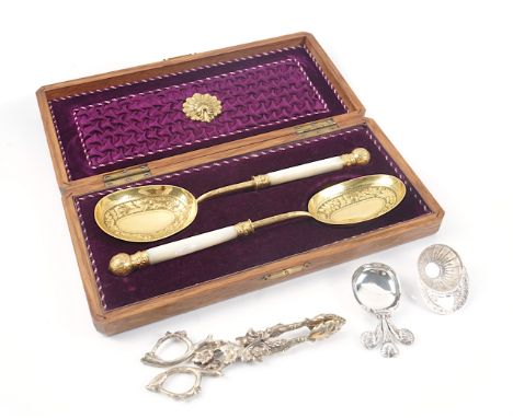 A PAIR OF RUSSIAN GILT SUGAR NIPS, TWO SILVER CADDY SPOONS AND A PAIR OF GILT SPOONS (4)The Russian gilt sugar nips cast with
